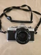 Minolta XG9 Black Silver 35mm SLR Film Camera with MD Rokkor-X 50mm Lens.