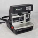 Vintage Polaroid Sun 600 LMS instant film camera with strap