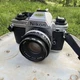 Nikon FG-20 Black Silver Vintage SLR Film Camera with Nikon 50mm f/1.8 Lens
