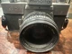 vintage Minolta SRT 102 35mm SLR film camera equipped with a Minolta MD Rokkor-X
