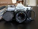 Canon AE-1 Program 35mm Film Camera with 50mm f/1.8 Lens Strap and Leather Case