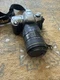 silver Nikon N65 35mm SLR film camera equipped with Quantaray 70-300mm f/4-5.6
