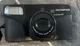 Used Olympus Zoom 211 35mm Point & Shoot Film Camera, Lens cover gets hung. 